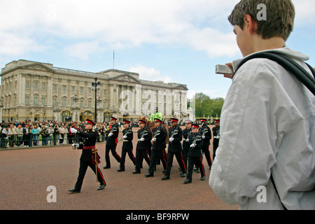 young boy taking pictures of the Changing of the Guard in front of Buckingham Palace, London, Great Britain Stock Photo