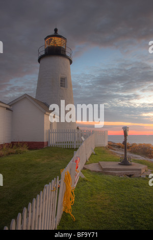 Pemaquid Point Lighthouse set against the pre-dawn sky which is beginning to glow prior to sunrise in Bristol, Maine. Stock Photo