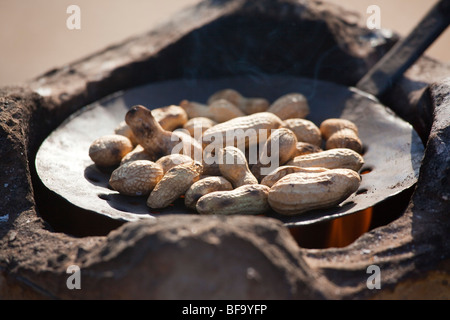 Peanuts Roasting on a fire at the Camel Fair in Pushkar India Stock Photo