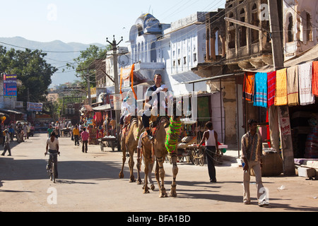 Tourists riding camels during the Camel Fair in Pushkar India Stock Photo