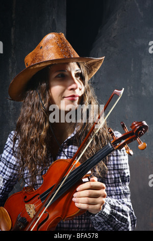 Beautiful violinist country performer on black background Stock Photo