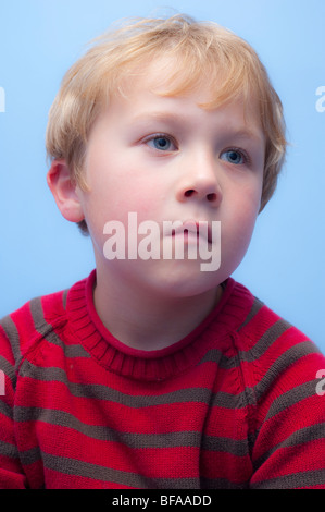 A Model Released picture of a six year old boy watching TV indoors in the Uk Stock Photo