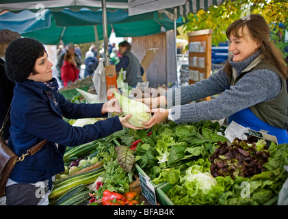 A young woman buying vegetable on a farmer's market , Berlin , Germany Stock Photo