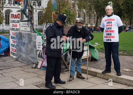Anti-War protester Brian Haw questioned by police at his peace camp in Parliament Square on Remembrance Sunday Stock Photo