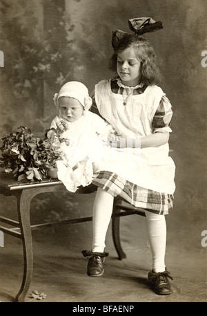 Little Girl with Infant Sibling Stock Photo