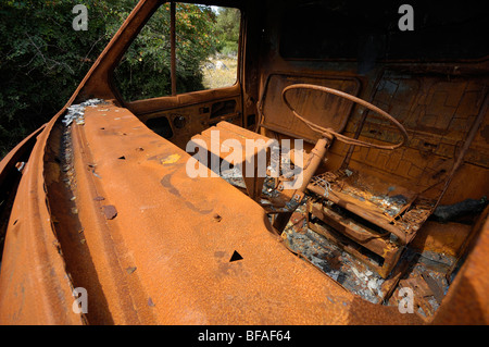 Dashboard  of rusty cab of delivery van, abandoned in a field, ecological pollution Stock Photo