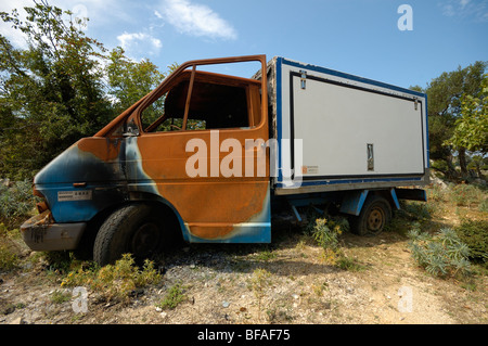 Rusty delivery van, refrigerator, abandoned in a field, ecological pollution Stock Photo