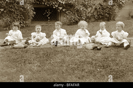 Six Little Children Playing on the Lawn Stock Photo