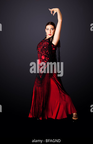 Beautiful female Spanish Flamenco dancer doing a typical line pose, wearing modern attire. Spanish woman dancing Paso Doble. Stock Photo