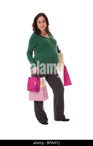 Beautiful happy exciting smiling Caucasian pregnant brunette woman holding shopping bags while standing, isolated Stock Photo