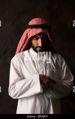 A view of a Muslim man praying alone outside the prayer room at sunset ...