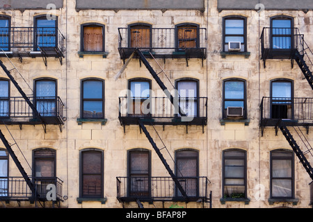 Wall of windows and fire escapes on old historic buildings in New York ...