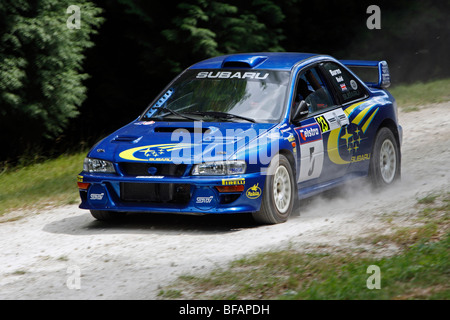 Richard Burns 1999 Subaru Impreza driven over the jump on the Rally Stage at Goodwood Festival Of Speed by Massimo Cappellini Stock Photo