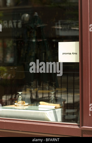 Upside down help wanted sign in a restaurant window Stock Photo