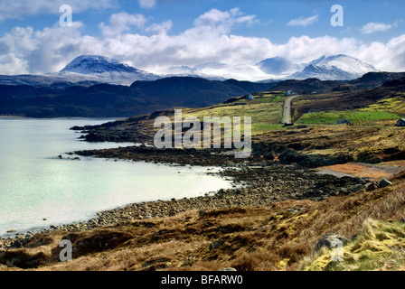 Scenic snowy mountain and coastal view towards Gruinard bay taken from the A832 road in Wester Ross, Scotland Stock Photo