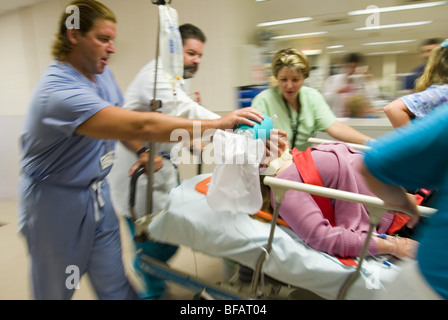 Emergency room, EMTs rush patient to operating room. Stock Photo