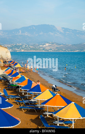 Xi beach near Lixouri on the Pali peninsular of Kefalonia - beach umbrellas and red sands Stock Photo