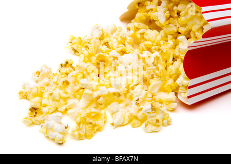 Spilled popcorn container isolated on white background. Stock Photo
