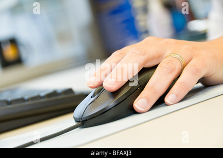 Hand on ergonomic computer mouse Stock Photo - Alamy