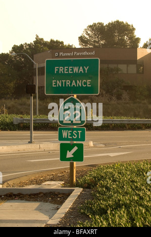 Sign for the 22 freeway (Garden Grove Freeway) in Orange, CA with the Planned Parenthood building visible in the background. Stock Photo