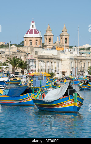 Colourful traditional fishing boats and restaurants at Marsaxlokk Malta. Stock Photo