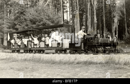 Engineer Driving Miniature Railroad with Kids Stock Photo