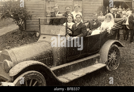 Bride & Groom in Mud Splattered Wedding Car Stock Photo