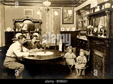 Couple with Twins Looking at Photograph Album Stock Photo