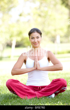 Pretty woman doing yoga meditation in the lotus position Stock Photo ...