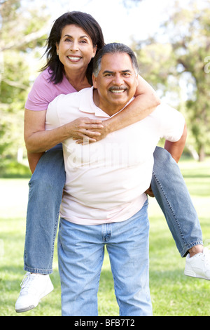 Senior Couple Having Fun In Park Stock Photo