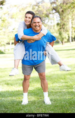 Senior Couple In Sports Clothing Having Fun In Park Stock Photo