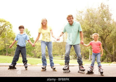 Family Wearing In Line Skates In Park Stock Photo