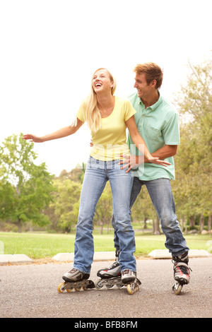 Couple Wearing In Line Skates In Park Stock Photo
