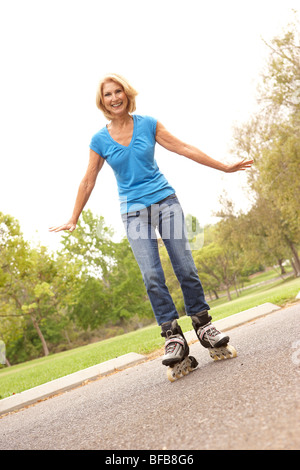 Senior Woman Skating In Park Stock Photo