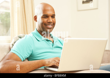 Man Using Laptop At Home Stock Photo