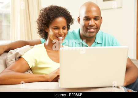 Couple Using Laptop At Home Stock Photo