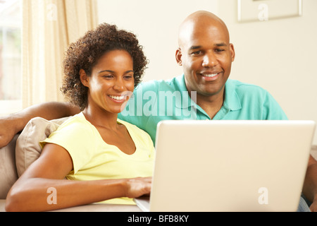 Couple Using Laptop At Home Stock Photo