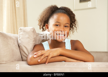 Young Girl Relaxing On Sofa At Home Stock Photo