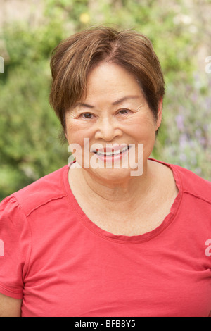 Portrait Of Smiling Senior Woman Outdoors Stock Photo