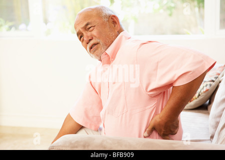Senior Man Suffering From Back Pain At Home Stock Photo