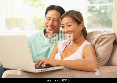 Young Couple Using Laptop At Home Stock Photo