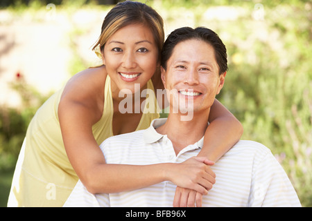 Young Couple Hugging In Garden Stock Photo