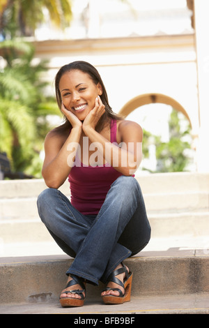 Young beautiful woman sitting on the floor on white background Stock ...