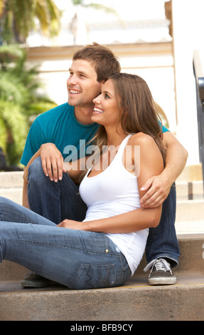Young Couple Sitting On Steps Of Building Stock Photo