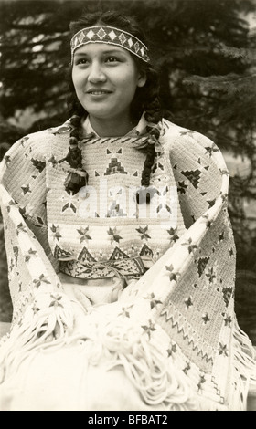 native American Indian girl in traditional costume herds horses in ...