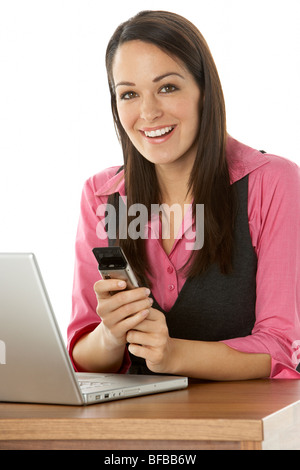 Female Businesswoman Using Laptop At Desk Stock Photo
