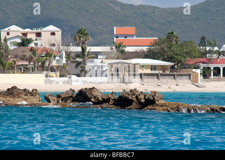 Jagged Rocks provide a hazard to navigation just off Bergeux Beach, Sint Maarten Stock Photo