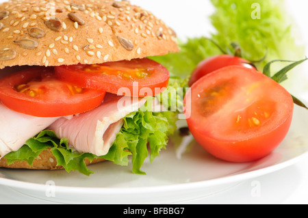 Close up of ham salad roll on white plate Stock Photo