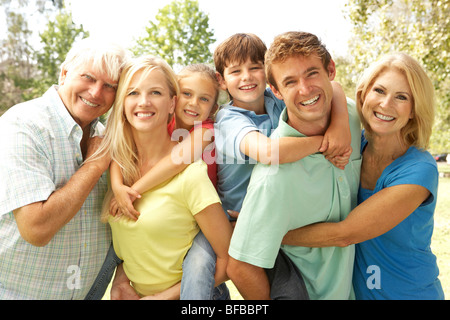 Mother And Father Giving Children Piggy Back With Grandparents Stock Photo
