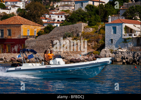 Inflatable boat in front of houses at the coastline of Hydra island, Greece Stock Photo